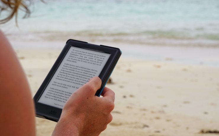 person holding black tablet computer during daytime