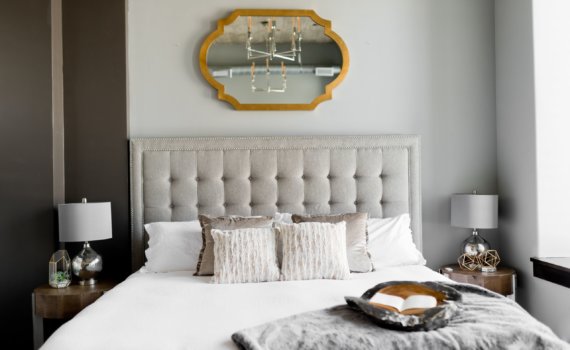 tufted white bed near window