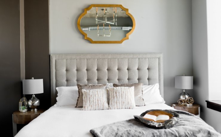 tufted white bed near window
