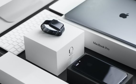 space black case Apple Watch, silver MacBook Pro, jet black iPhone 7 Plus, and silver iMac with corresponding boxes