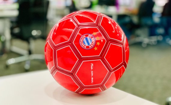 red soccer ball on white table
