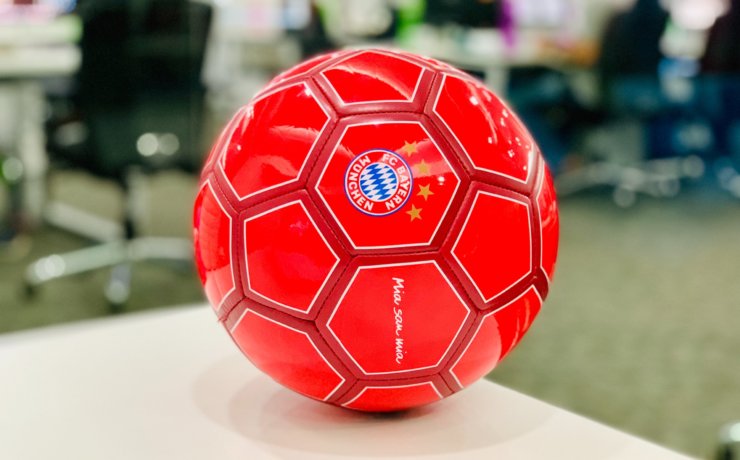 red soccer ball on white table