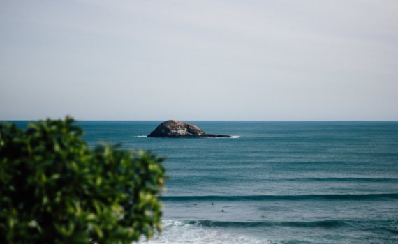 island near swimming people