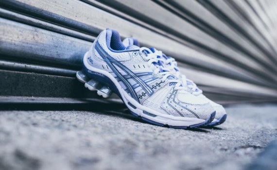 pair of white-and-purple Asics sneakers