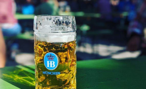 near full Munchen drinking glass on green surface