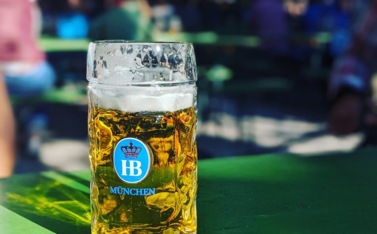 near full Munchen drinking glass on green surface