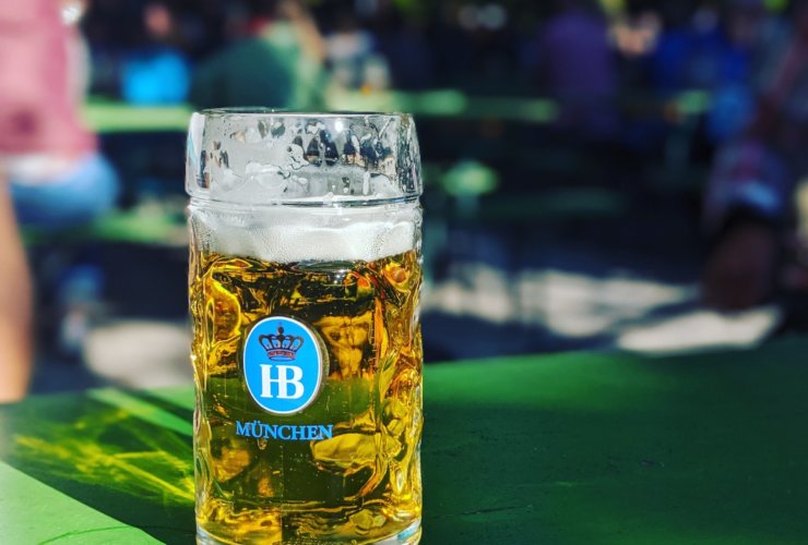 near full Munchen drinking glass on green surface