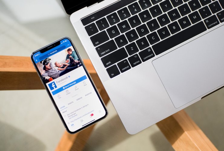 iPhone X beside MacBook