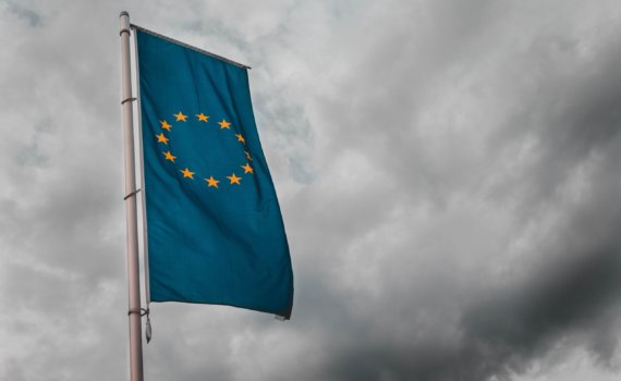 teal flag under cloudy sky