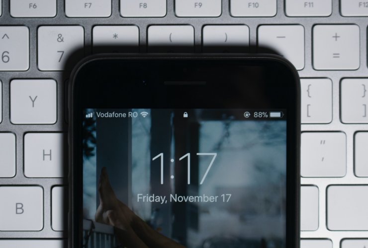 black iPhone on gray computer keyboard