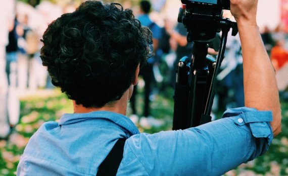 man holding DSLR camera