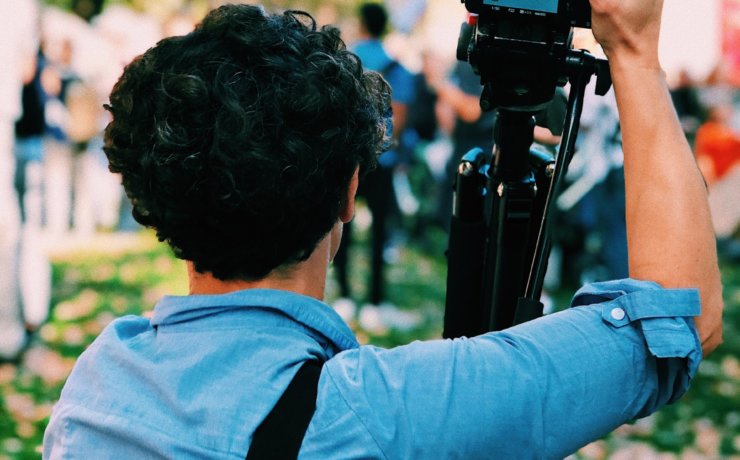 man holding DSLR camera