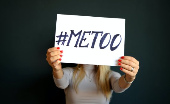 woman holding paper with metoo sign written