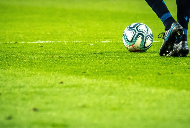 man playing soccer game on field