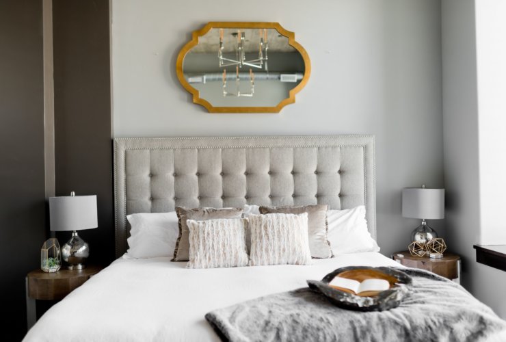 tufted white bed near window