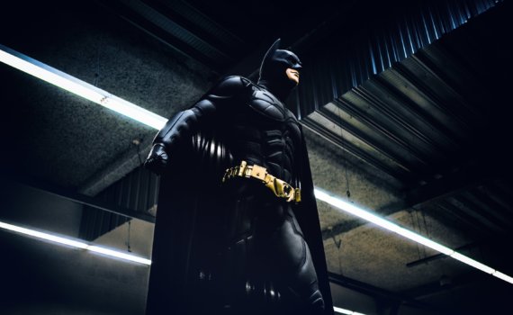 Batman standing under steel roof