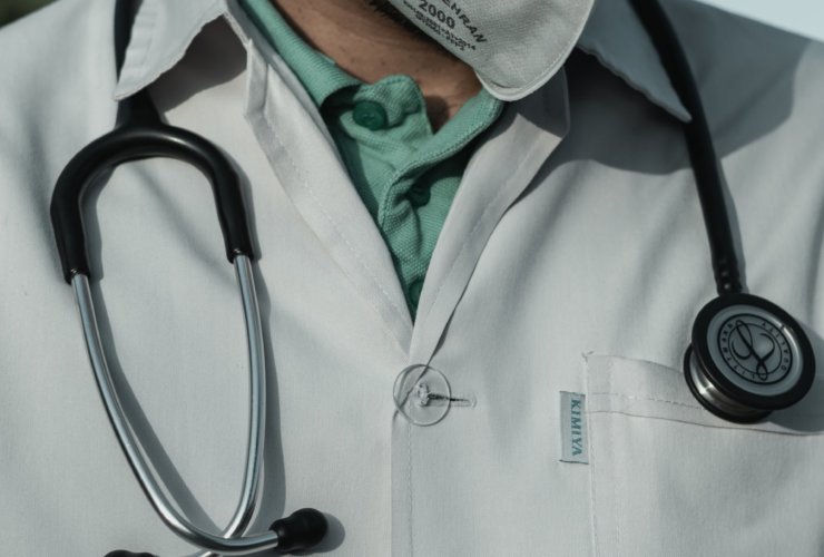 person in white and black stethoscope