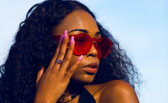 woman holding her sunglasses