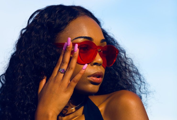 woman holding her sunglasses